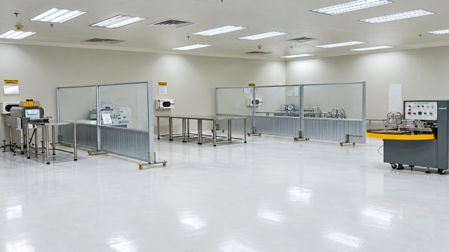 Pharmaceutical factory for sale in Ho Chi Minh City, Vietnam, featuring a modern cleanroom with industrial equipment, partitioned workstations, and bright interior lighting