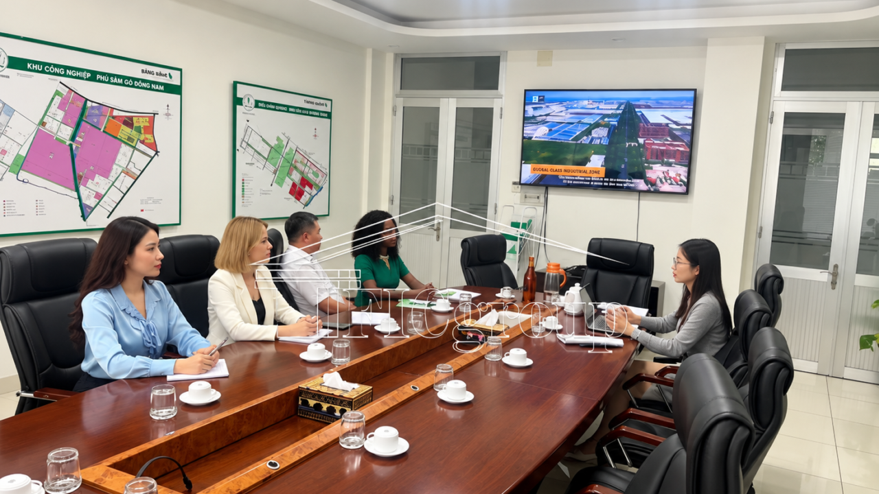 Group of business visitors inspecting a vacant industrial land site in Vietnam, reviewing documents and discussing potential investment opportunities.